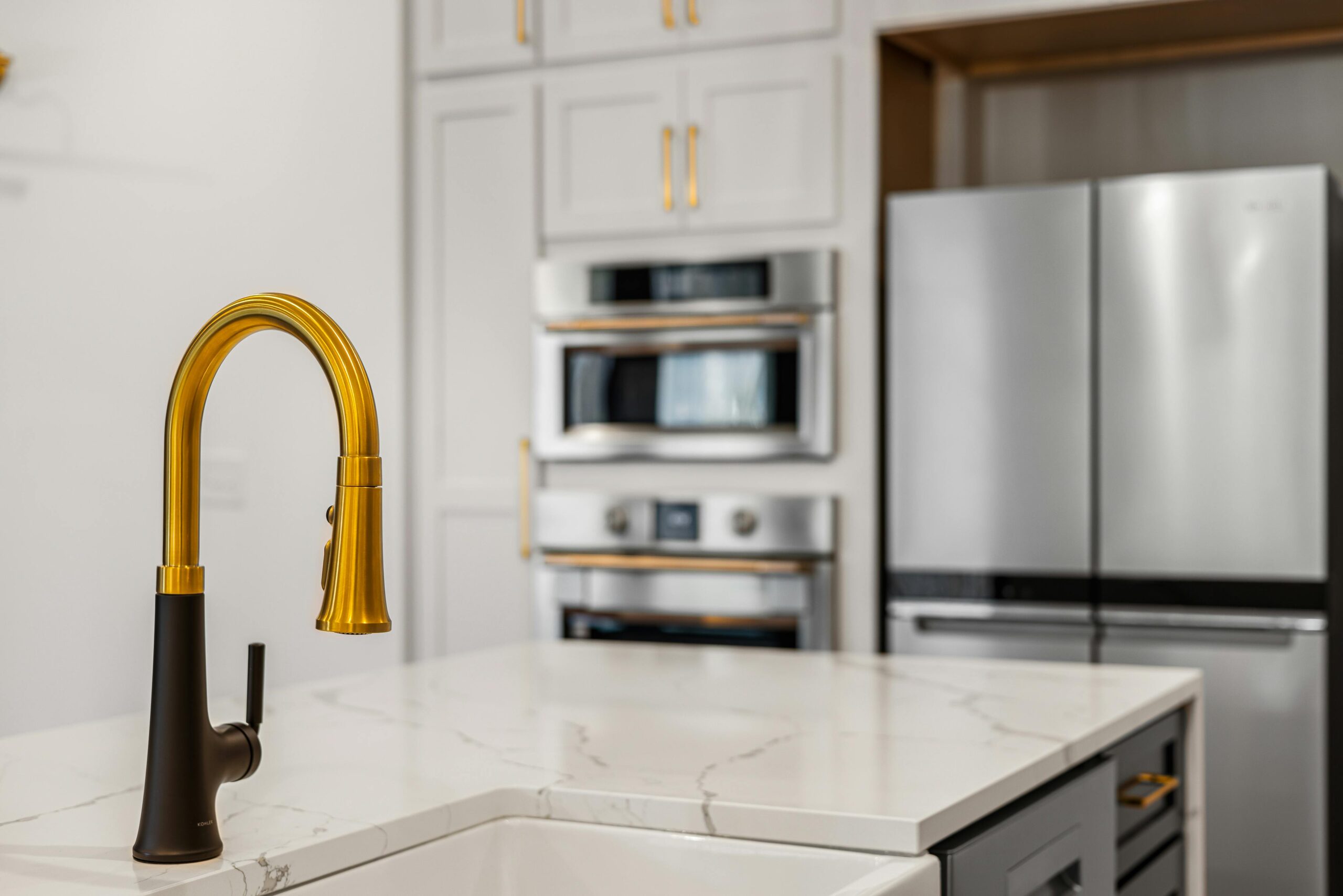 remodeled kitchen with gold faucet